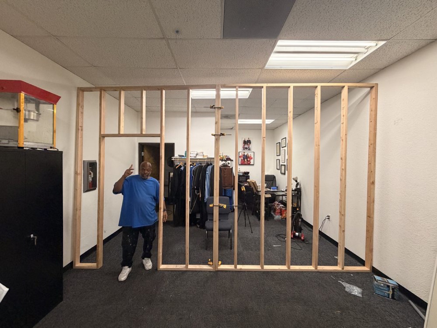 A new wall framed with wood studs inside an office